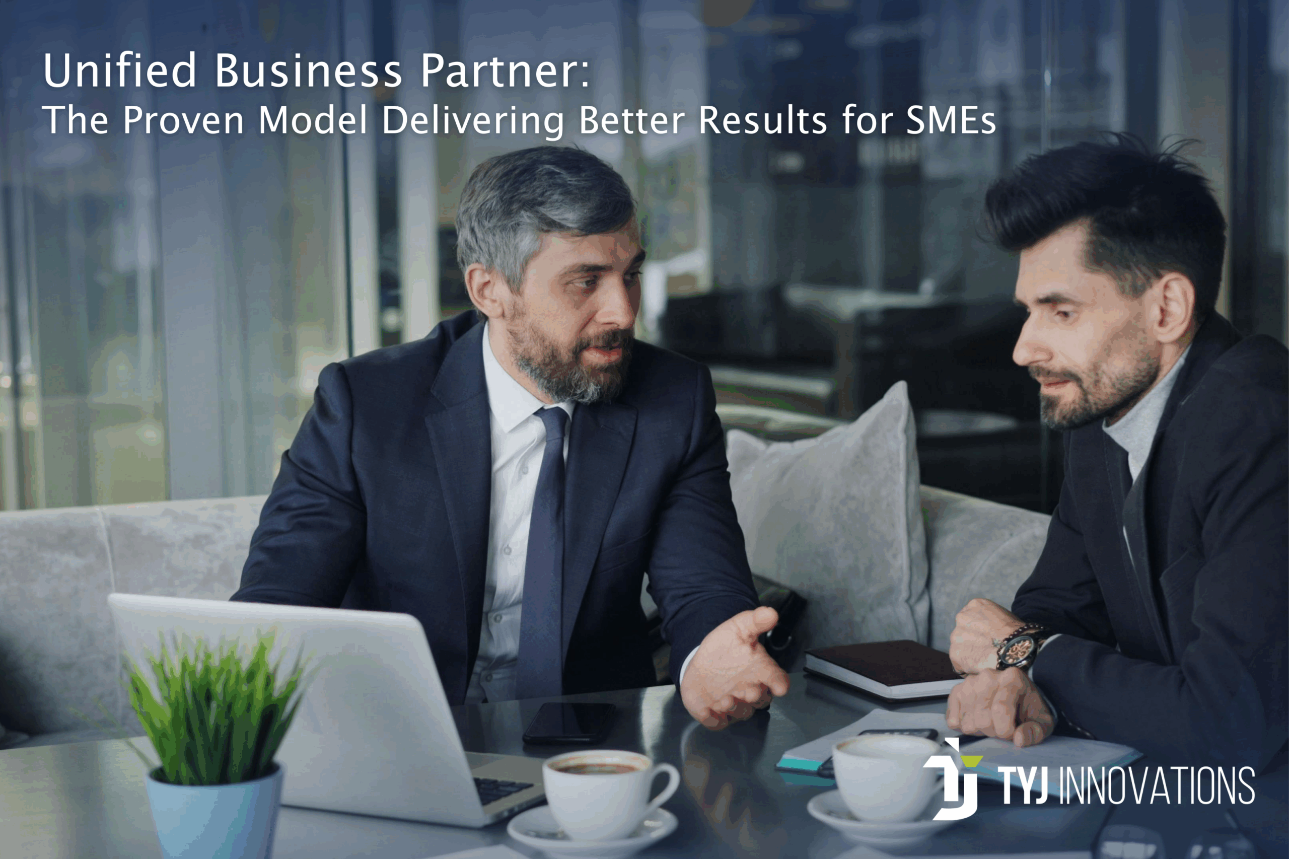 Two professionals discussing strategy in a business meeting, representing the unified business partner model used by TYJ Innovations to support SMEs.